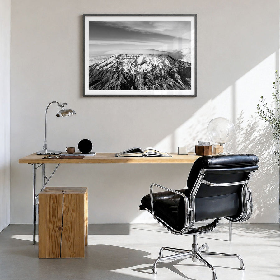 Mount Kilimanjaro Photo Poster in a black wood frame, hanging in a bright home office, white border