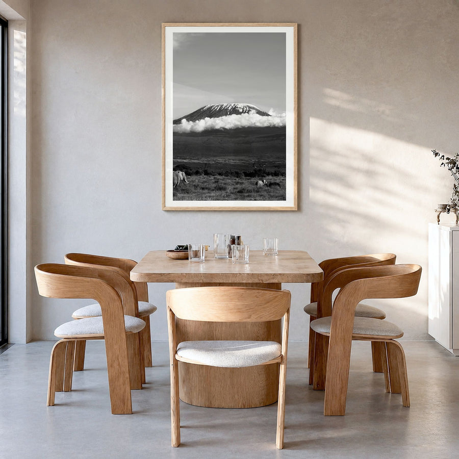 Mount Kilimanjaro Photo Poster in a natural wood frame, hanging in a dining room, white border
