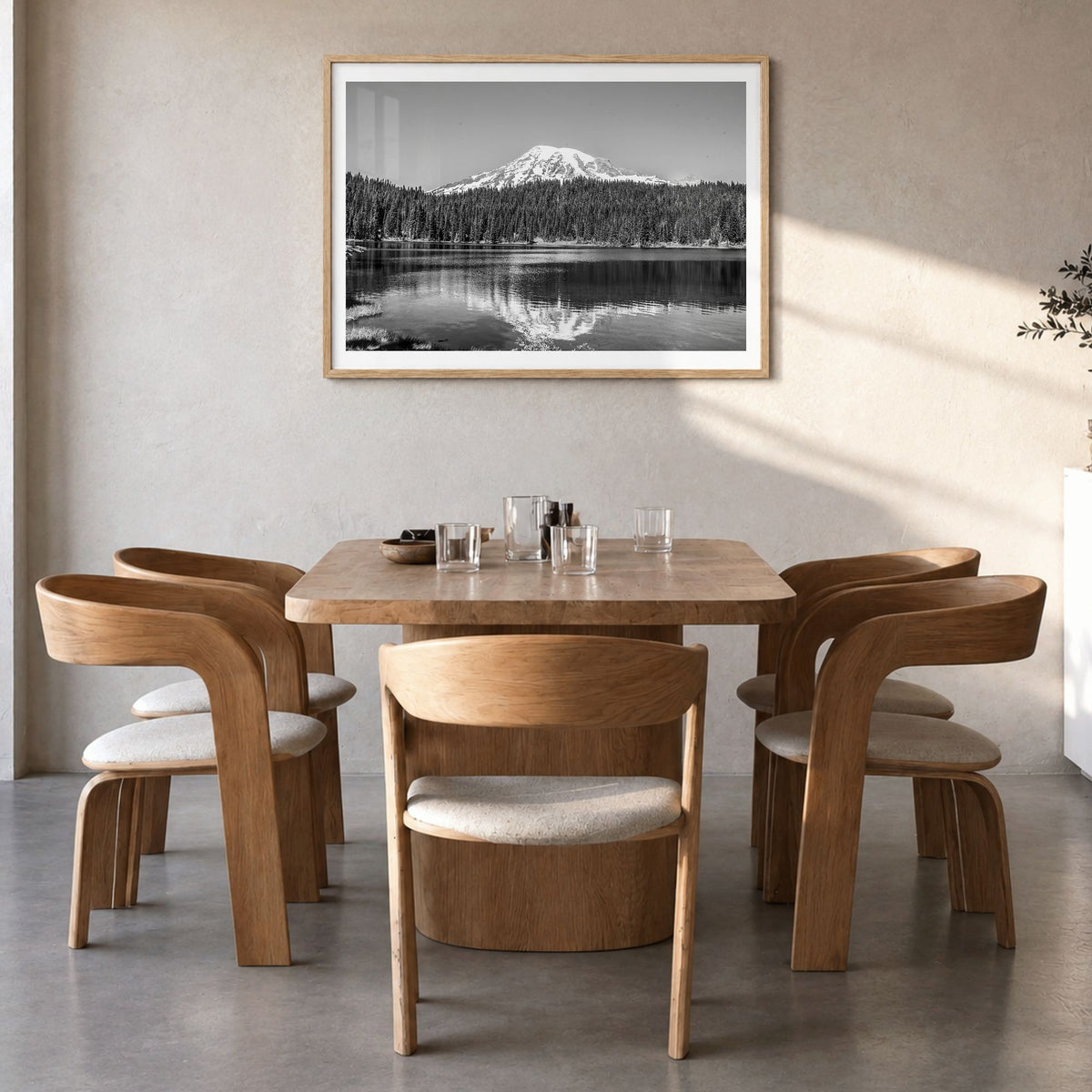 Mount Rainier Photo Poster in a natural wood frame, hanging in a dining room, white border