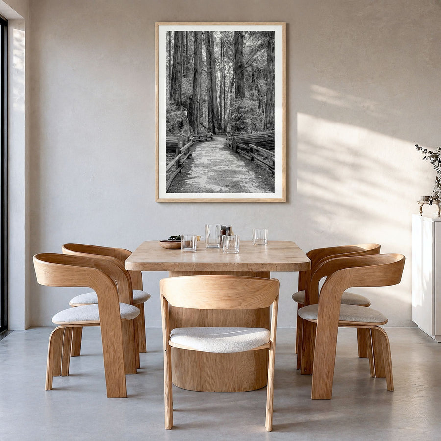 Muir Woods National Monument Photo Poster in a natural wood frame, hanging in a dining room, white border