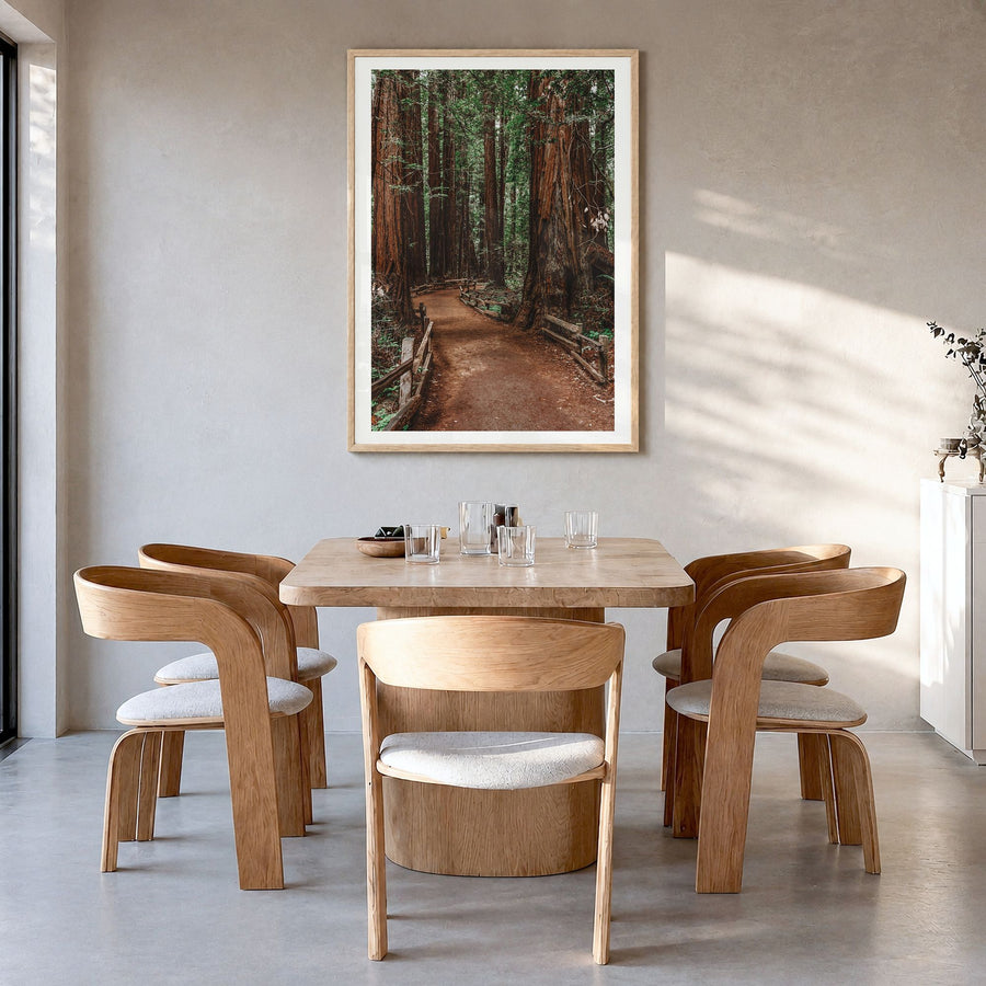 Muir Woods National Monument Photo Poster in a natural wood frame, hanging in a dining room, white border