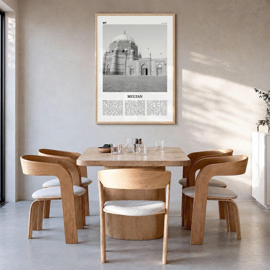 Multan Newspaper Poster in a natural wood frame, hanging in a dining room