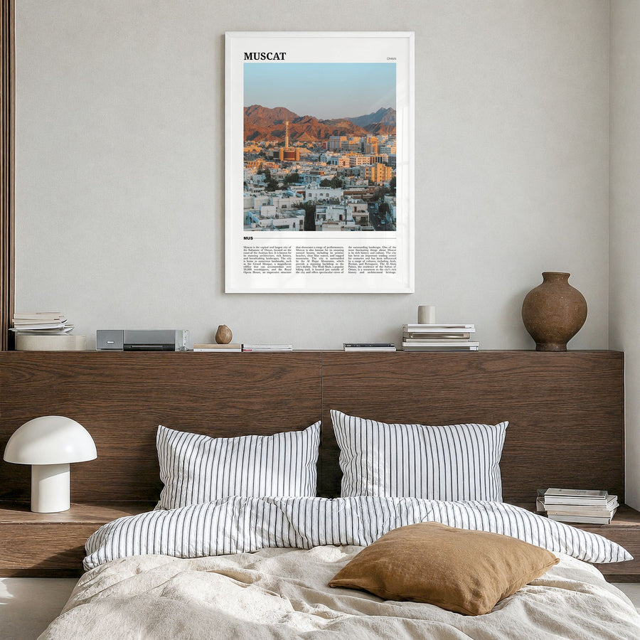 Muscat Travel Poster in a white wood frame, hanging in a bedroom