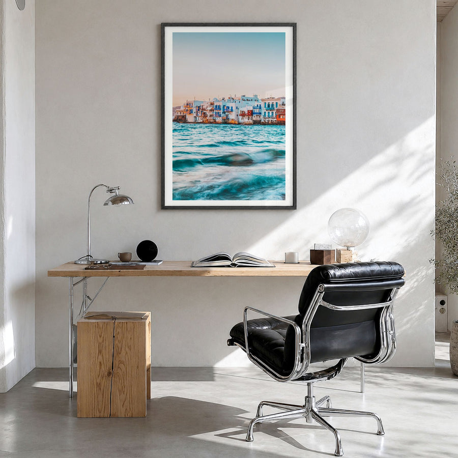 Mykonos Photo Poster in a black wood frame, hanging in a bright home office, white border