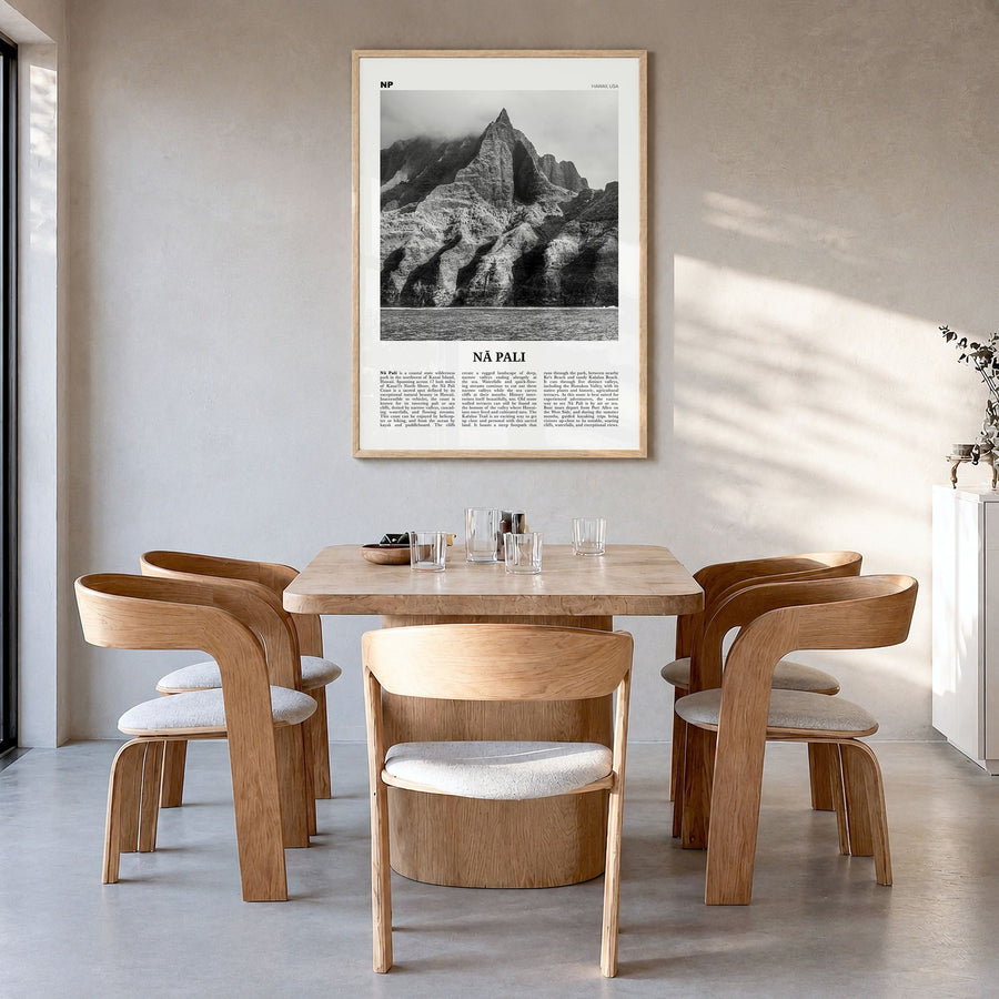 Nā Pali Newspaper Poster in a natural wood frame, hanging in a dining room