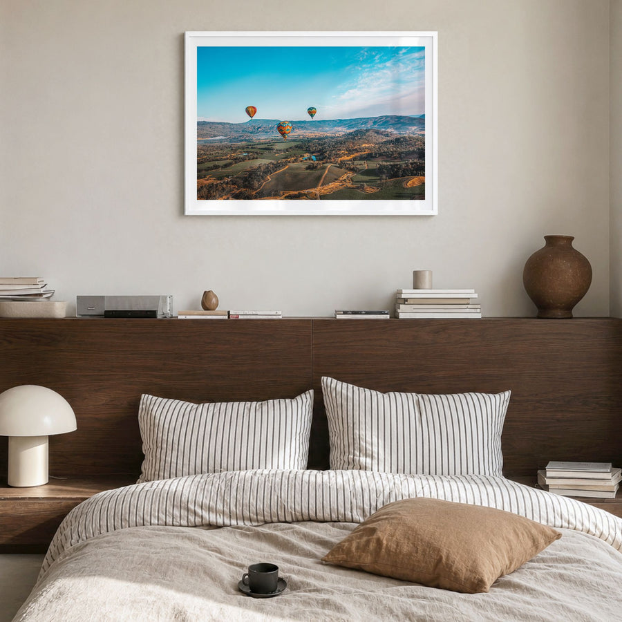Napa Valley Photo Poster in a white wood frame, hanging in a bedroom, white border