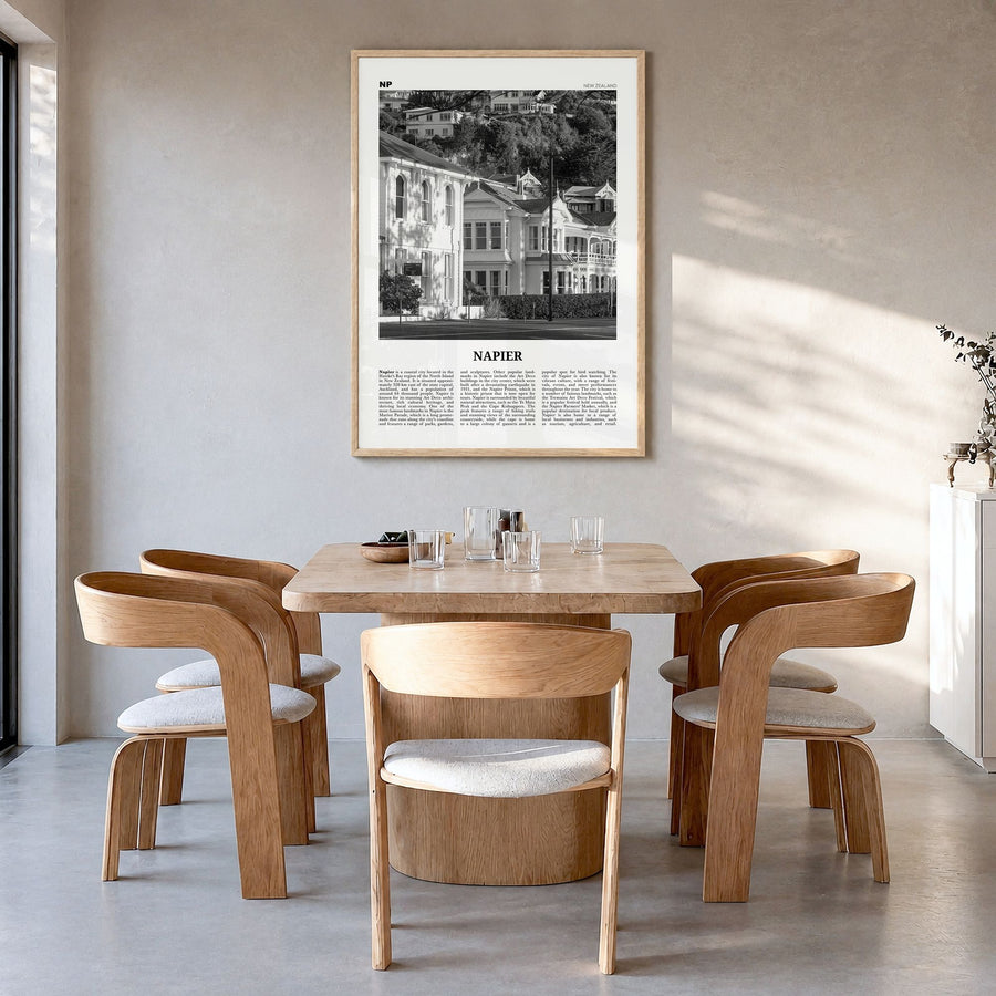 Napier Newspaper Poster in a natural wood frame, hanging in a dining room