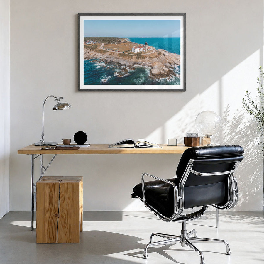 Narragansett Photo Poster in a black wood frame, hanging in a bright home office, white border