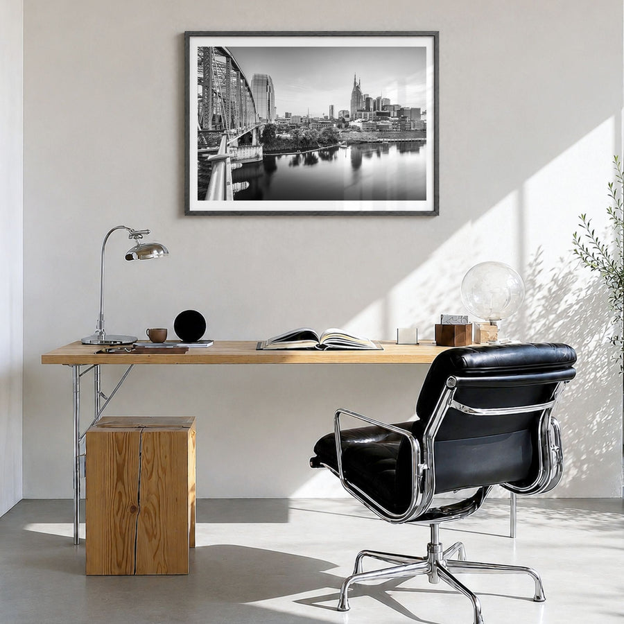 Nashville Photo Poster in a black wood frame, hanging in a bright home office, white border