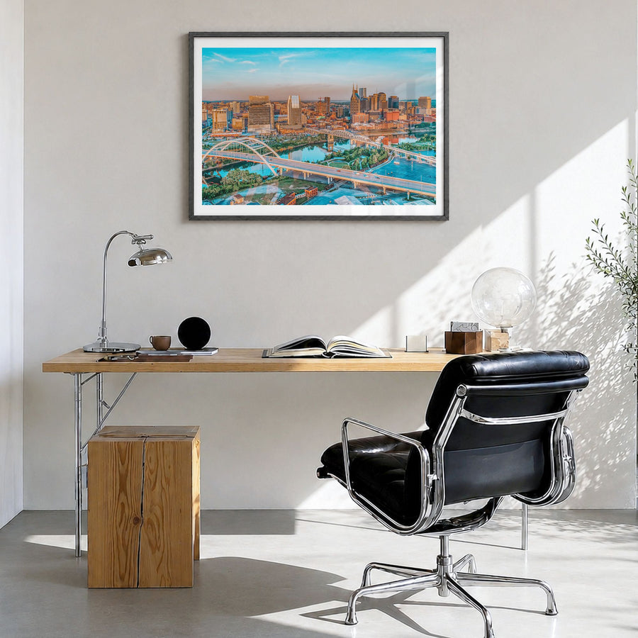 Nashville Photo Poster in a black wood frame, hanging in a bright home office, white border