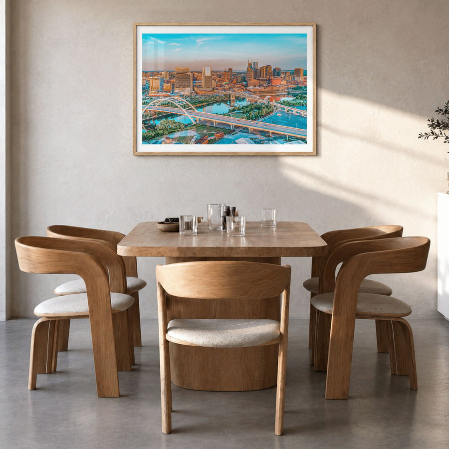 Nashville Photo Poster in a natural wood frame, hanging in a dining room, white border