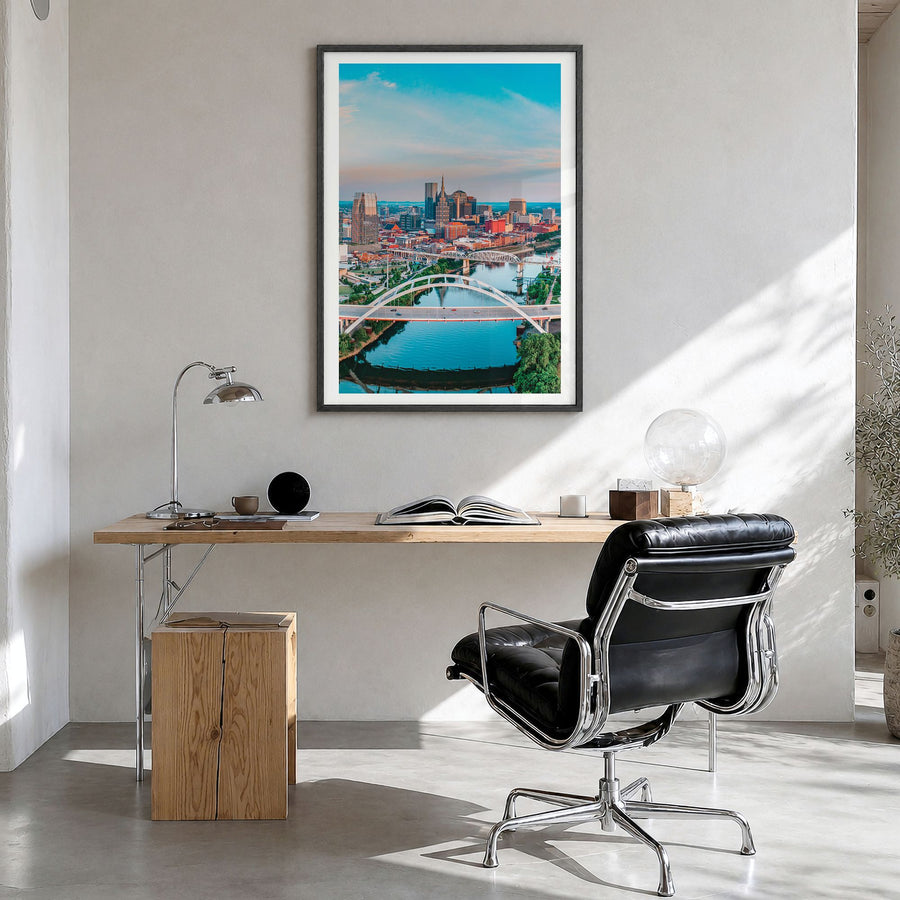 Nashville Photo Poster in a black wood frame, hanging in a bright home office, white border