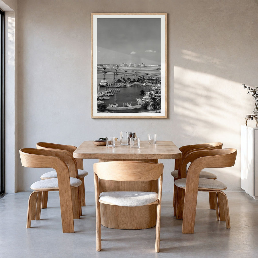 Nassau Photo Poster in a natural wood frame, hanging in a dining room, white border