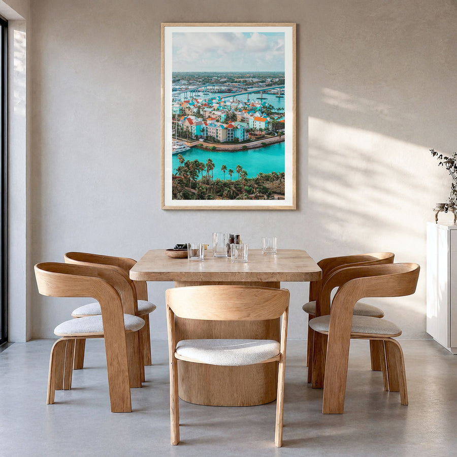 Nassau Photo Poster in a natural wood frame, hanging in a dining room, white border