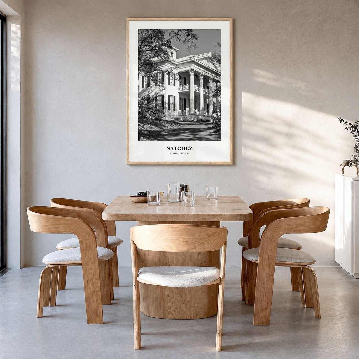 Natchez Classic Poster in a natural wood frame, hanging in a dining room