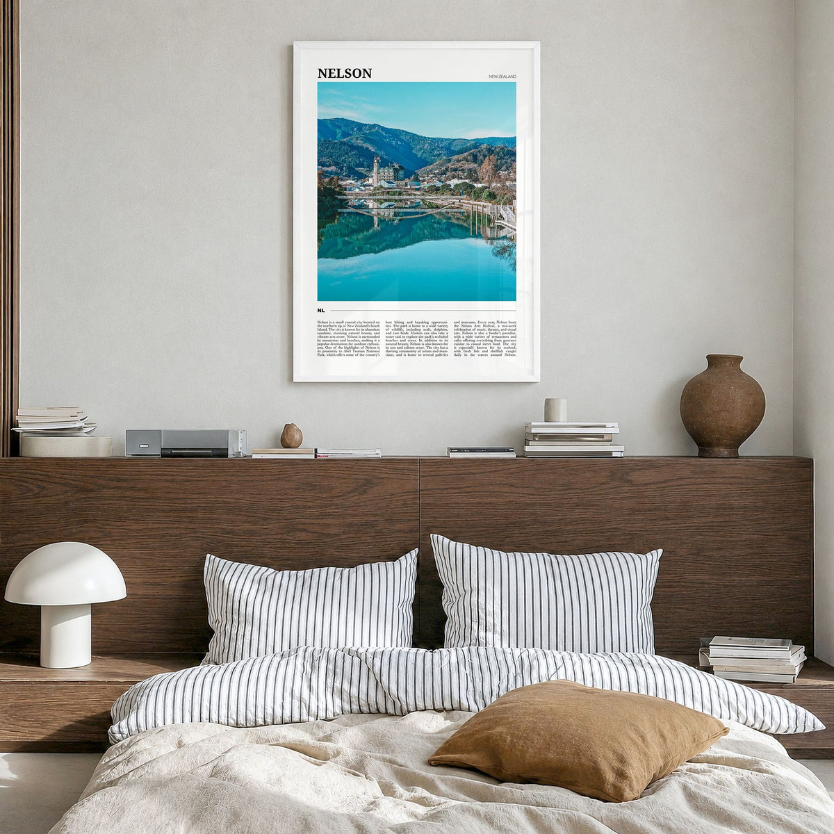 Nelson Travel Poster in a white wood frame, hanging in a bedroom
