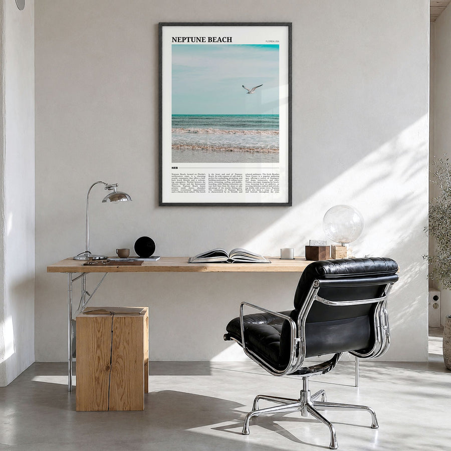 Neptune Beach Travel Poster in a black wood frame, hanging in a bright home office