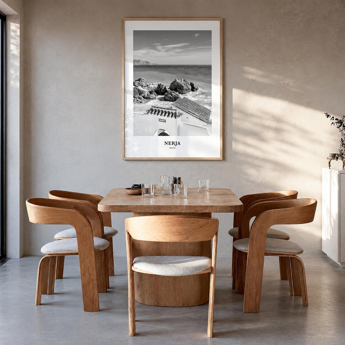 Nerja black & white classic poster of Spain – vertical wall art in natural wood frame, hanging on wall