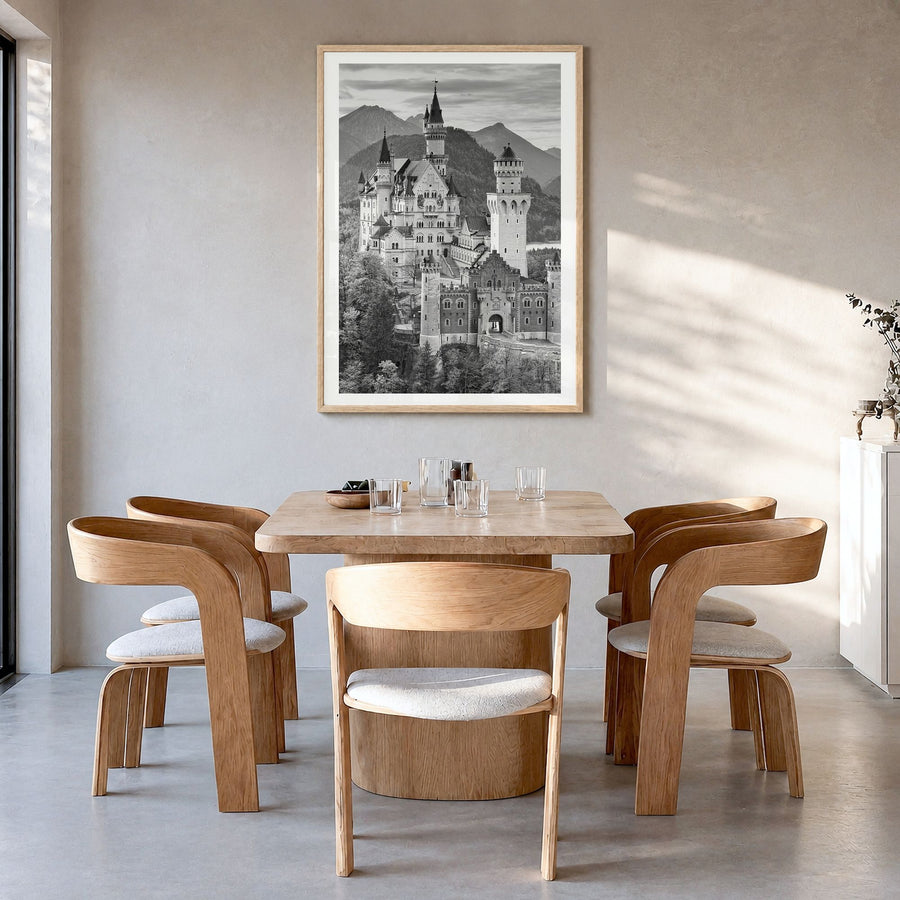 Neuschwanstein Castle Photo Poster in a natural wood frame, hanging in a dining room, white border