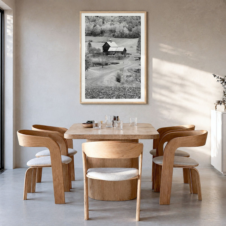 New England Photo Poster in a natural wood frame, hanging in a dining room, white border
