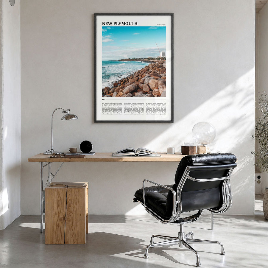 New Plymouth Travel Poster in a black wood frame, hanging in a bright home office
