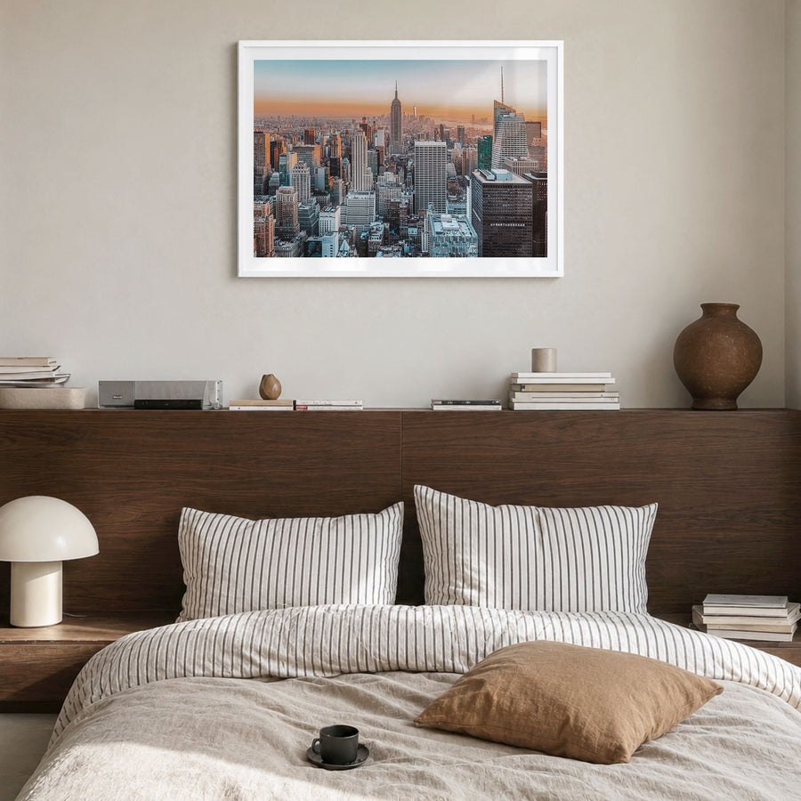 New York City Photo Poster in a white wood frame, hanging in a bedroom, white border