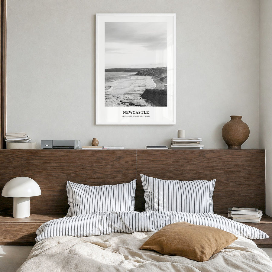 Newcastle, Australia Classic Poster in a white wood frame, hanging in a bedroom