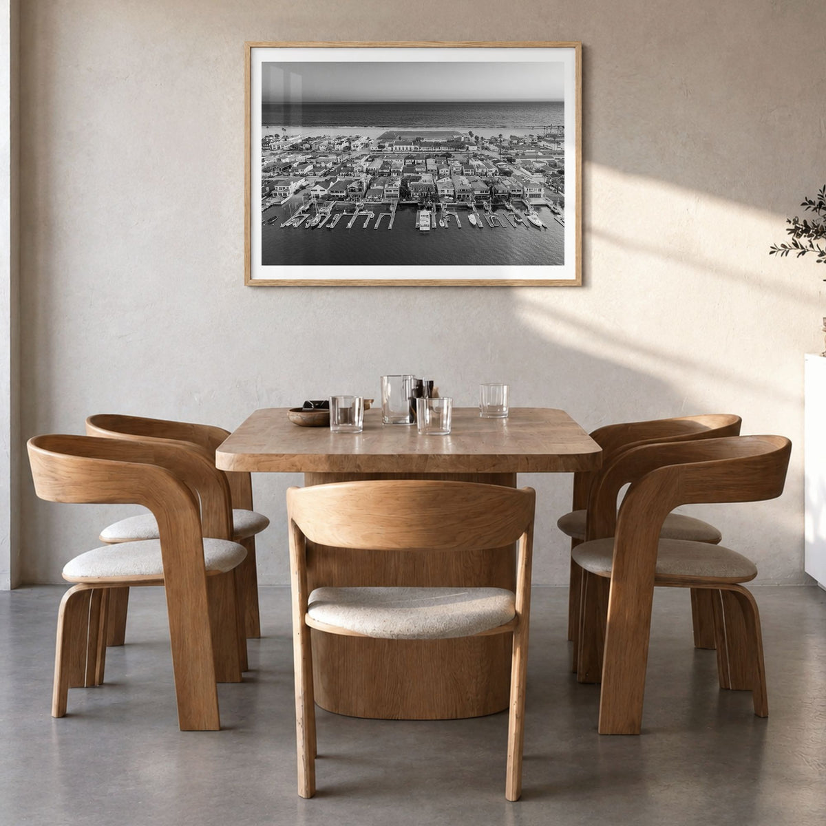 Newport Beach Photo Poster in a natural wood frame, hanging in a dining room, white border