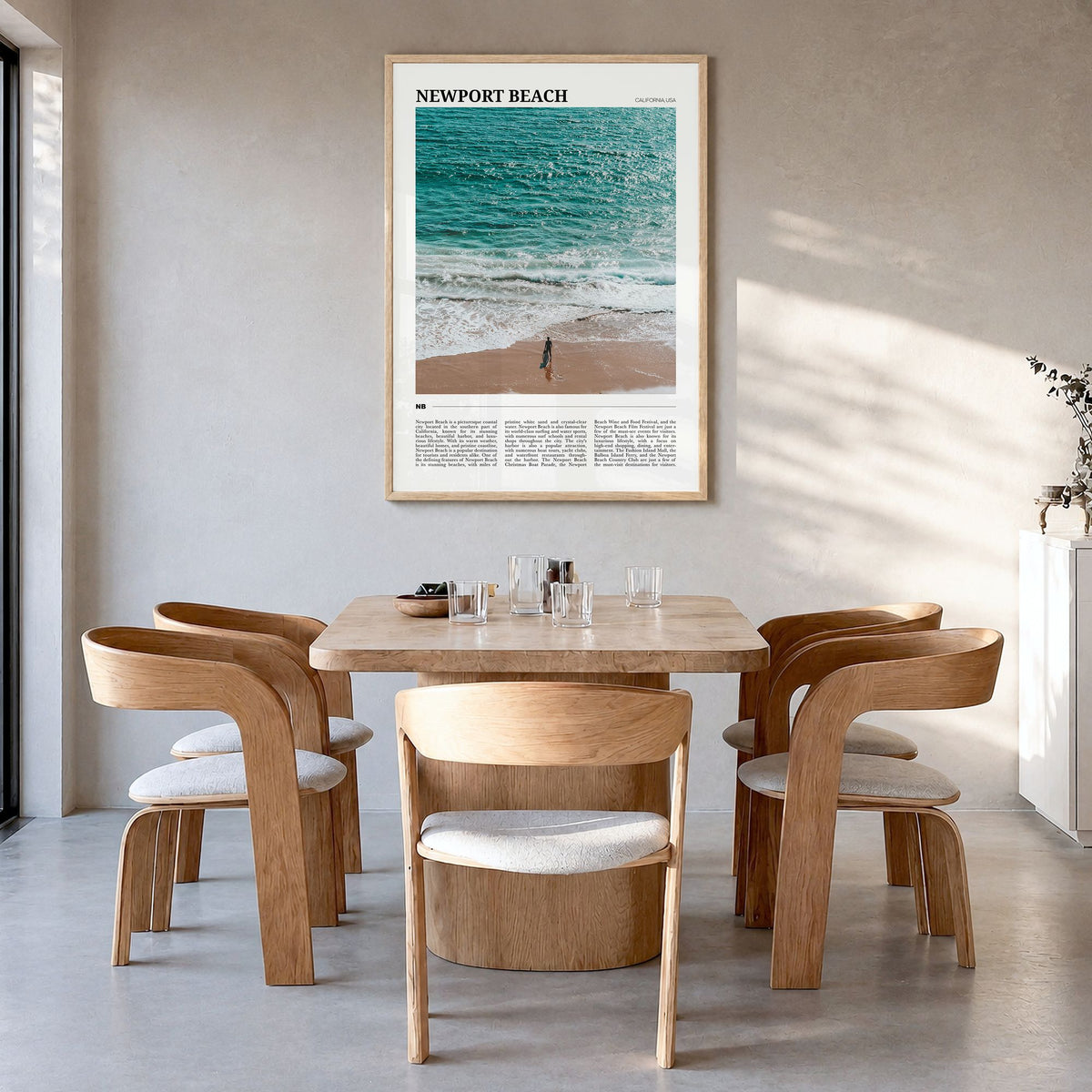 Newport Beach Travel Poster in a natural wood frame, hanging in a dining room