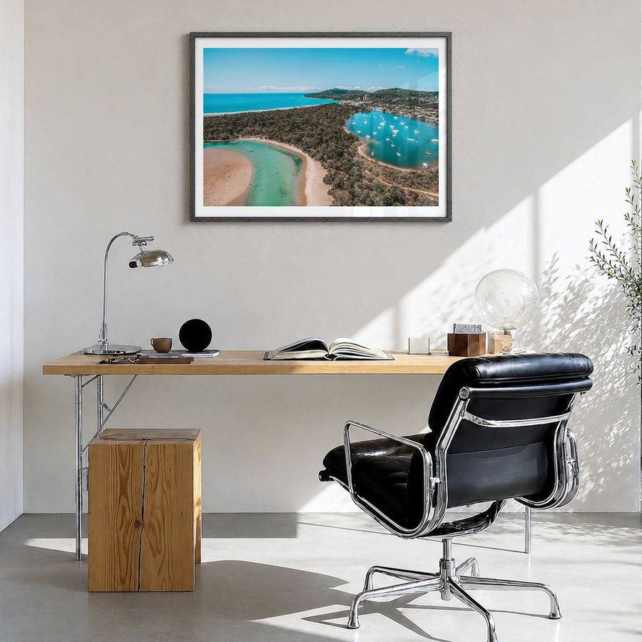 Noosa Heads Photo Poster in a black wood frame, hanging in a bright home office, white border