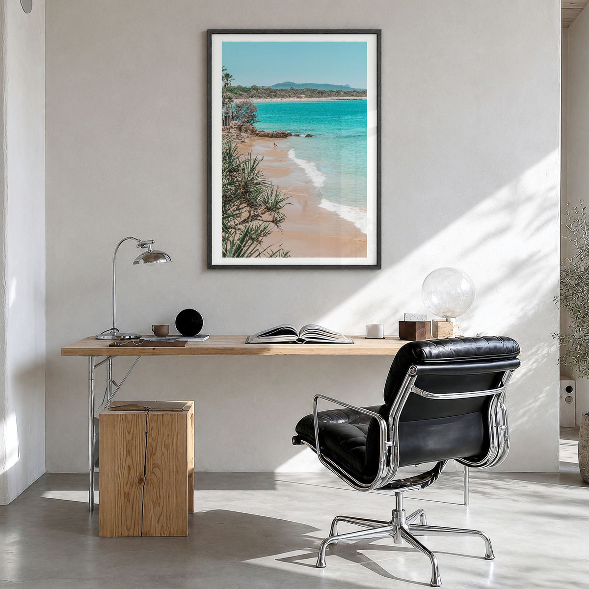 Noosa Heads Photo Poster in a black wood frame, hanging in a bright home office, white border