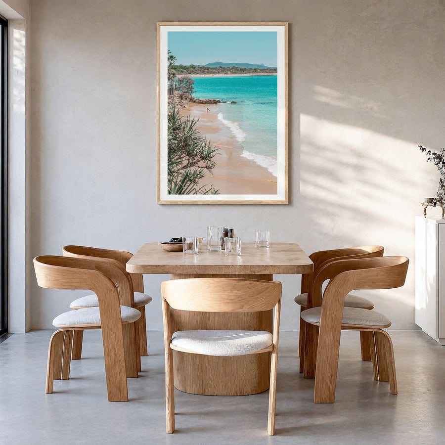 Noosa Heads Photo Poster in a natural wood frame, hanging in a dining room, white border