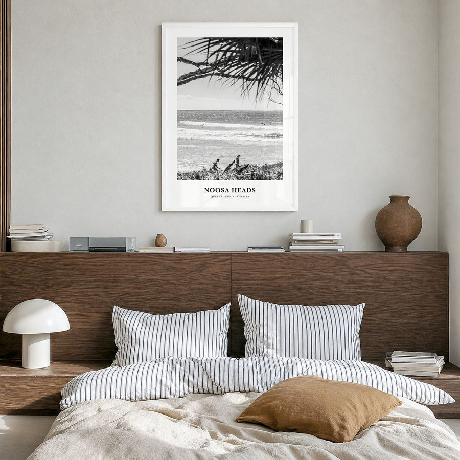 Noosa Heads Classic No 2 Poster in a white wood frame, hanging in a bedroom