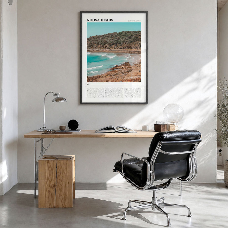 Noosa Heads Travel Poster in a black wood frame, hanging in a bright home office