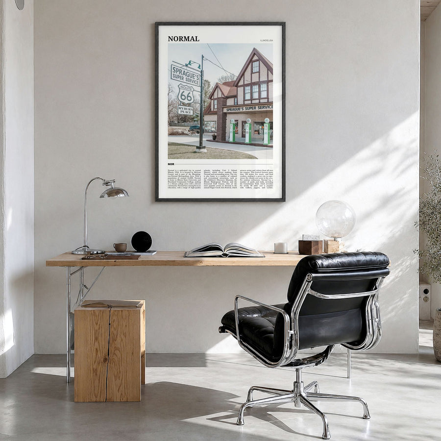 Normal Travel Poster in a black wood frame, hanging in a bright home office