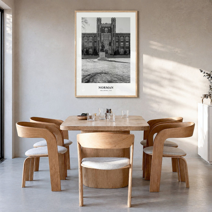 Norman Classic Poster in a natural wood frame, hanging in a dining room