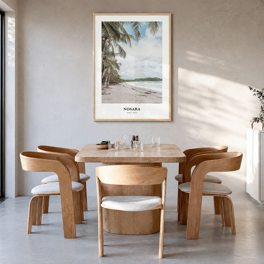 Nosara Classic Poster in a natural wood frame, hanging in a dining room