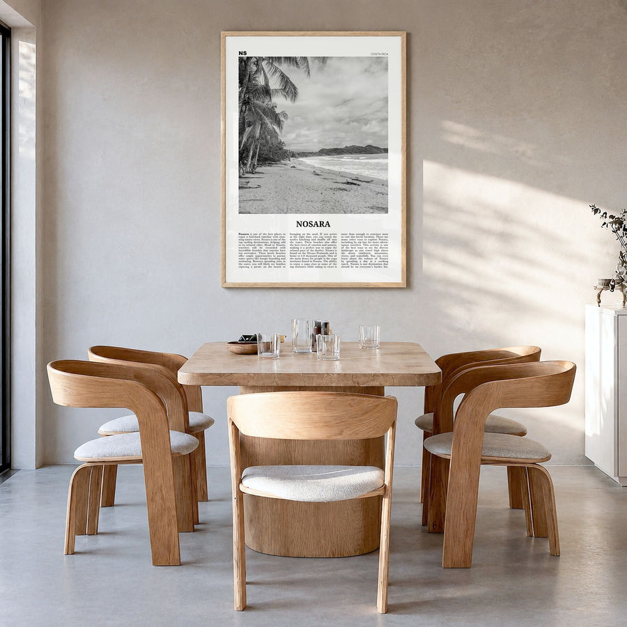 Nosara Newspaper Poster in a natural wood frame, hanging in a dining room