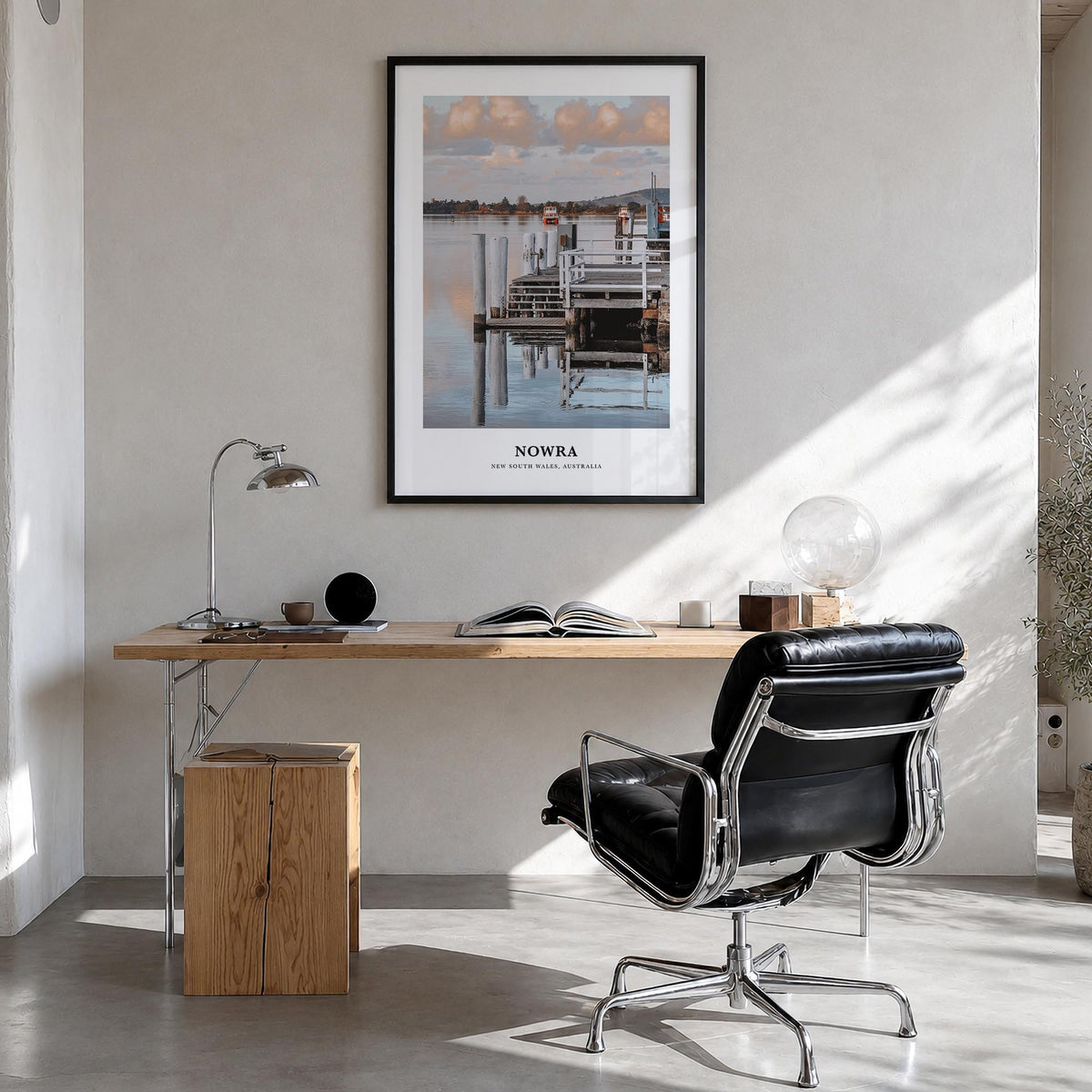 Nowra colorful classic poster of Australia – vertical wall art in black wood frame, hanging on wall