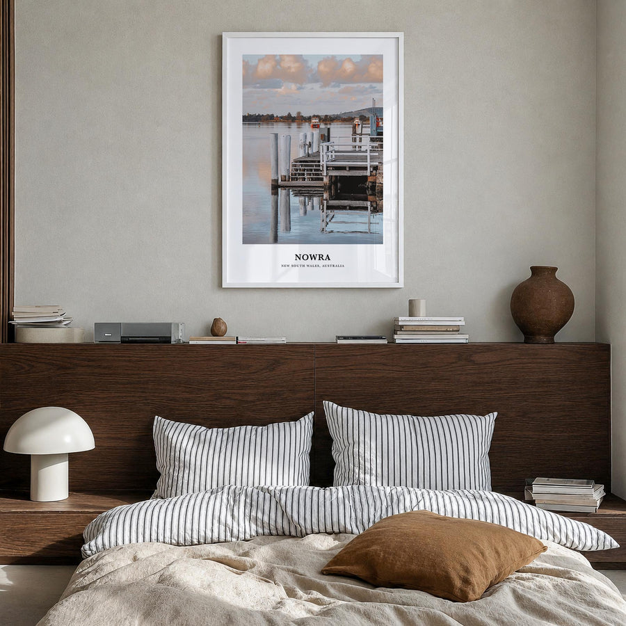 Nowra colorful classic poster of Australia – vertical wall art in white wood frame, hanging on wall