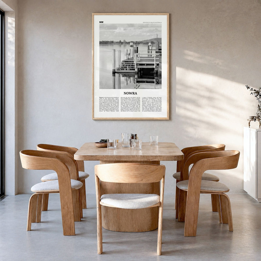 Nowra Newspaper Poster in a natural wood frame, hanging in a dining room
