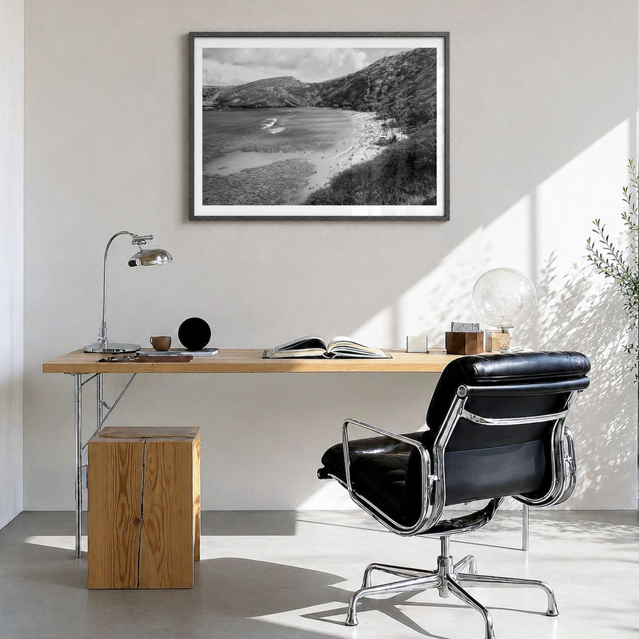O‘ahu Photo Poster in a black wood frame, hanging in a bright home office, white border
