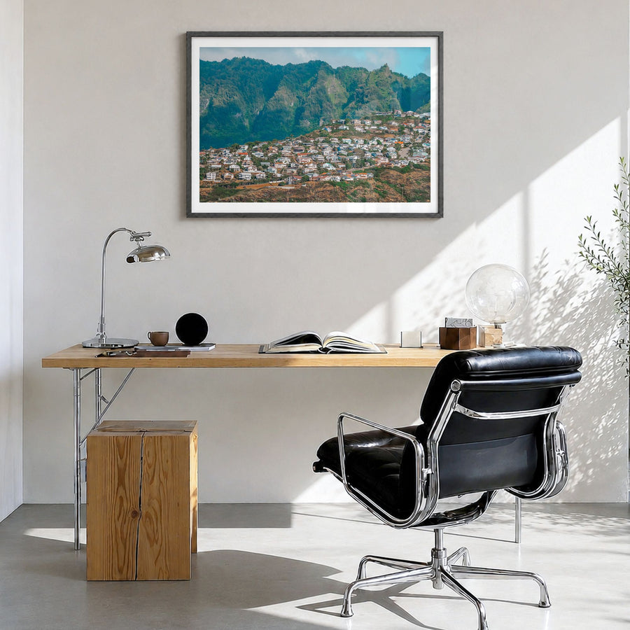 O‘ahu Photo Poster in a black wood frame, hanging in a bright home office, white border
