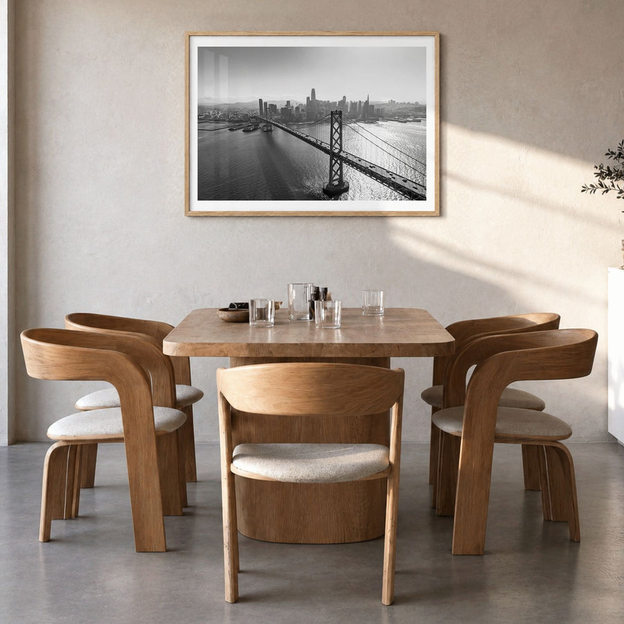 Oakland Photo Poster in a natural wood frame, hanging in a dining room, white border