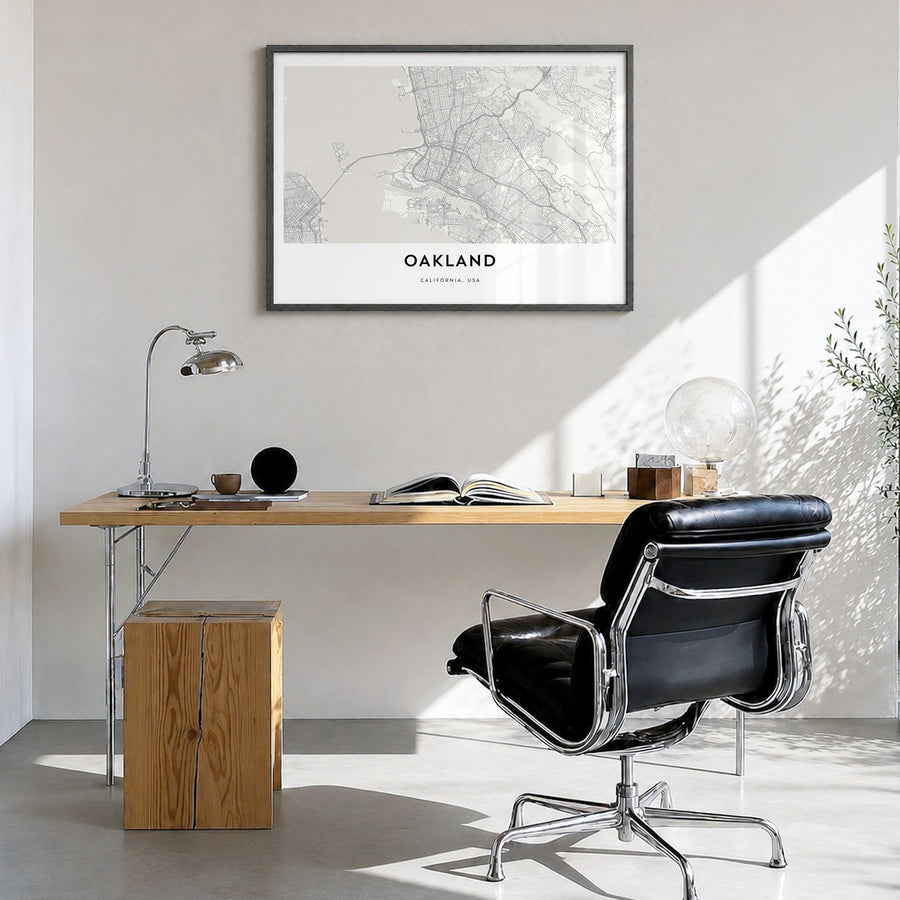 Oakland Map Poster in a black wood frame, hanging in a bright home office