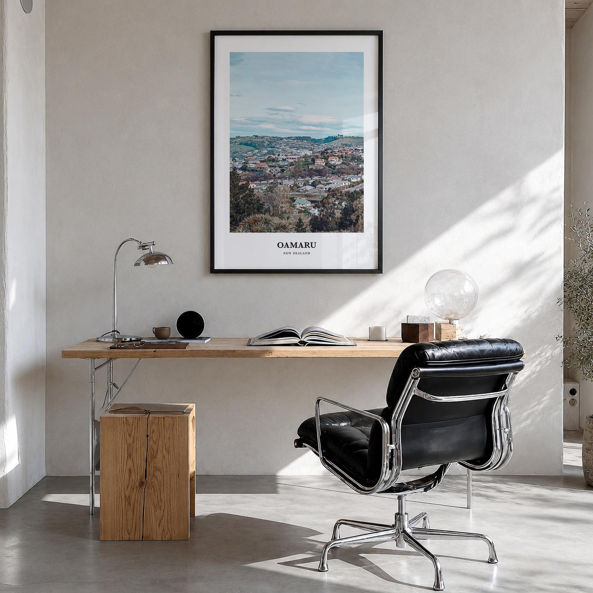 Oamaru colorful classic poster of New Zealand – vertical wall art in black wood frame, hanging on wall