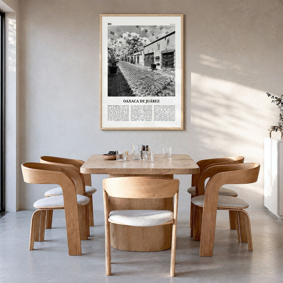 Oaxaca de Juárez Newspaper Poster in a natural wood frame, hanging in a dining room