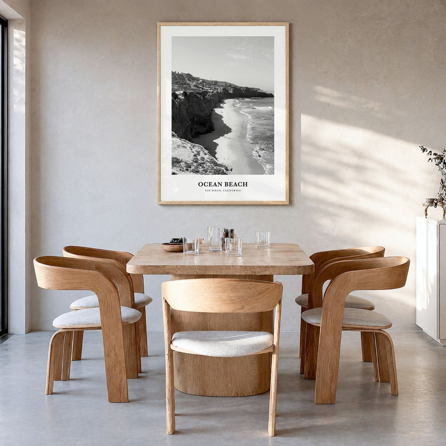 Ocean Beach Classic Poster in a natural wood frame, hanging in a dining room