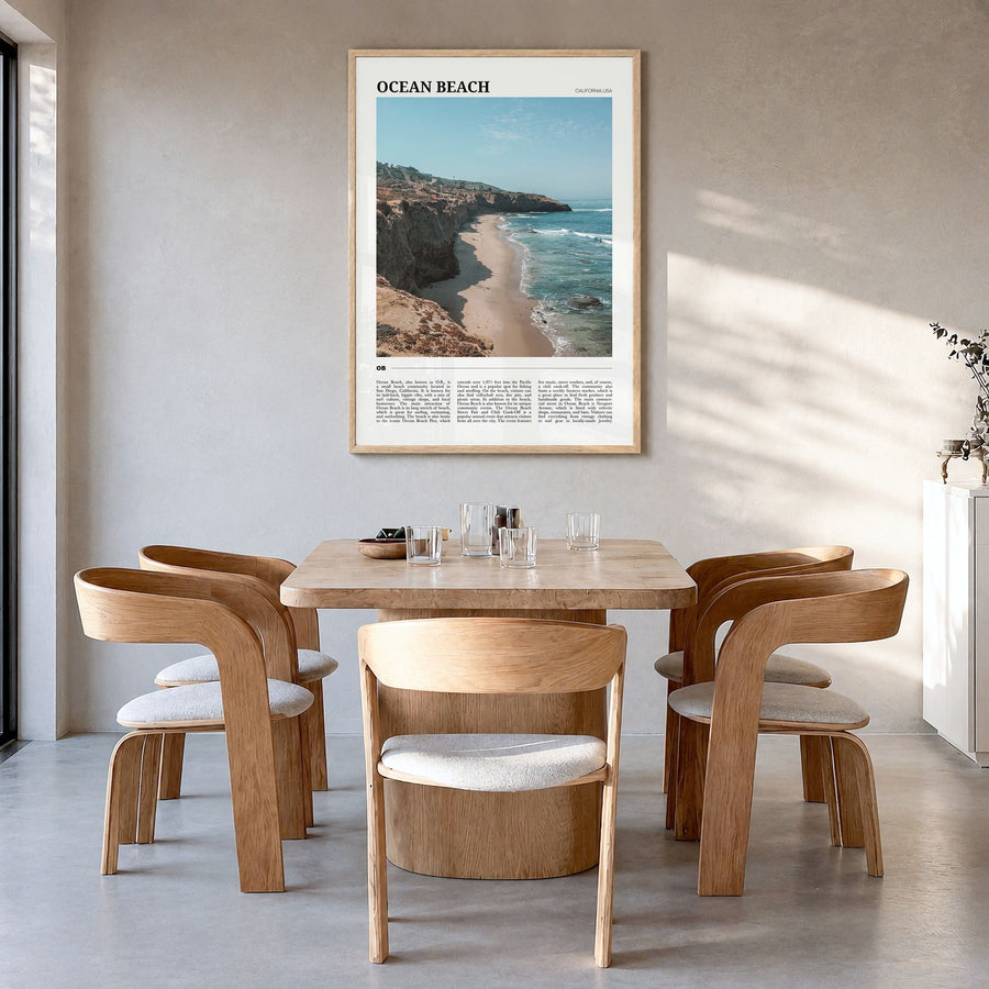 Ocean Beach Travel Poster in a natural wood frame, hanging in a dining room