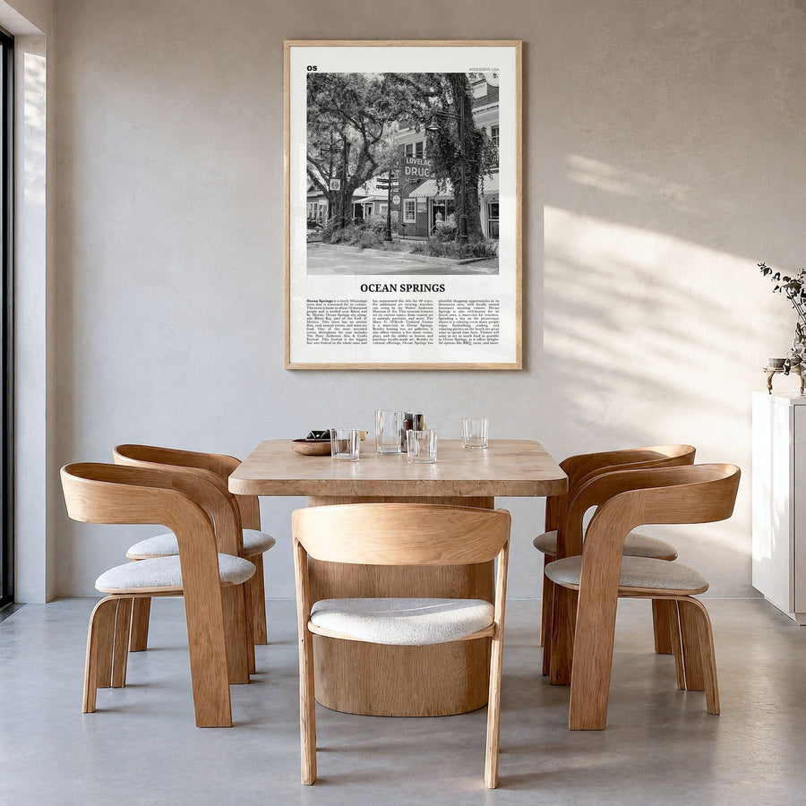 Ocean Springs Newspaper Poster in a natural wood frame, hanging in a dining room